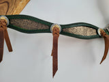 Gold floral inlay on green leather breast collar with blood knot leather ties on conchos