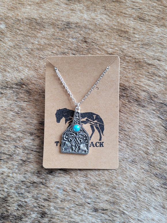 Tooled cow ear tag with turquoise necklace